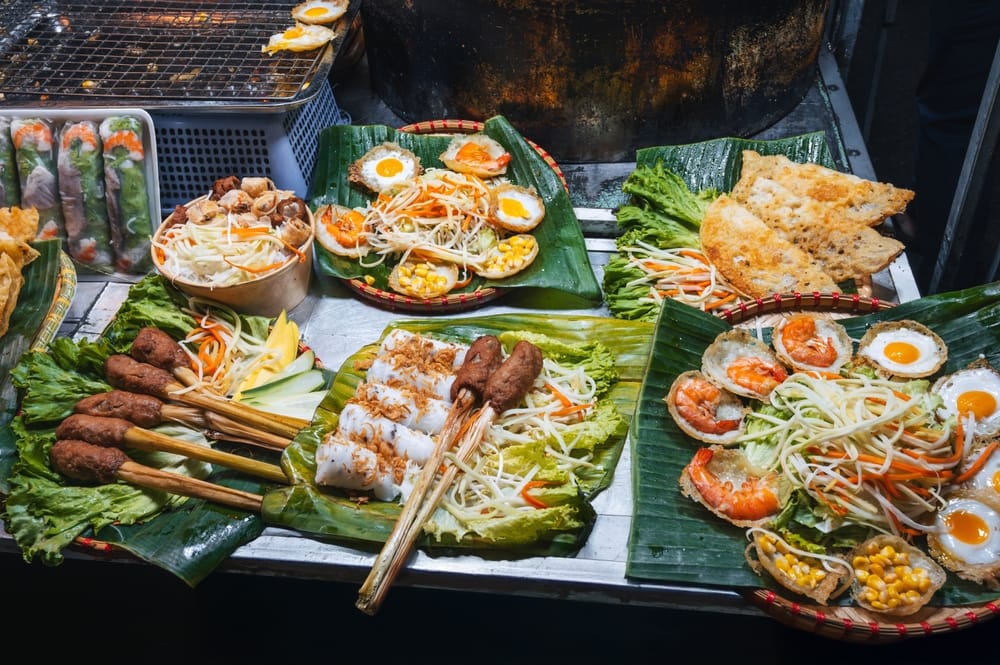 Farverige boder på et asiatisk natmarked byder på duftende, traditionel vietnamesisk street food.