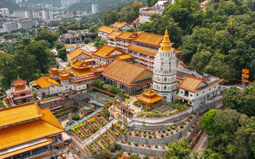 Stort buddhistisk tempelkompleks i det nordlige Malaysia omgivet af frodig natur og gyldne tage